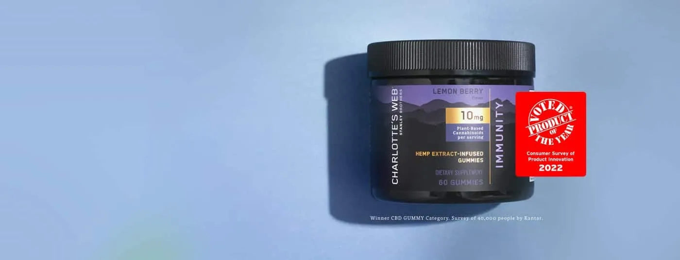 A jar of Charlotte's Web Immunity Gummy against a blue background.