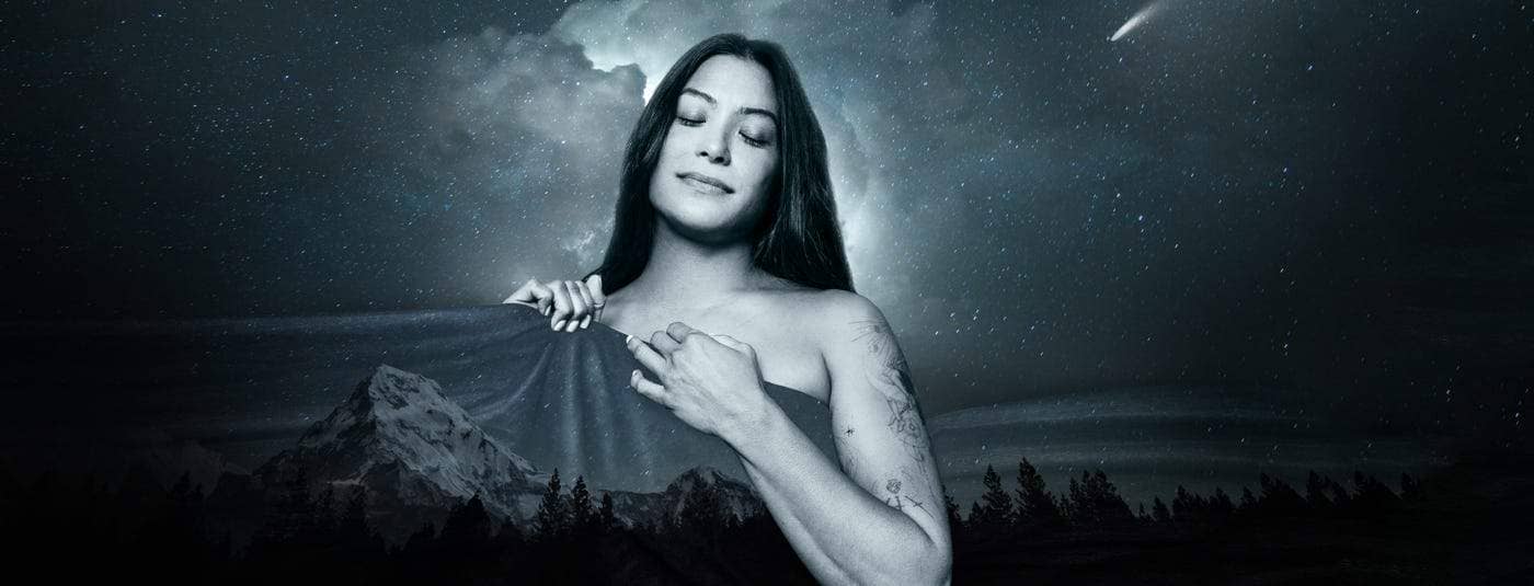 An illustration of a woman in black and white pulling a blanket over her amongst a nature background at night.