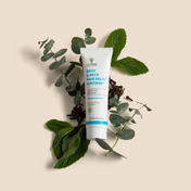 Product Image for Tube of back neck pain relief ointment surrounded by green leaves on a beige background