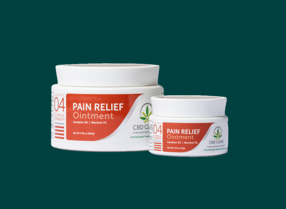 Two jars of CBD Clinic Pain Relief Ointment on a green background