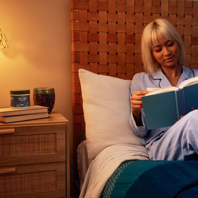 Woman reading a book in bed with a warm ambiance