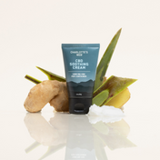 Product Image for Tube of Charlotte&#39;s Web CBD Soothing Cream with aloe vera leaves on a white background