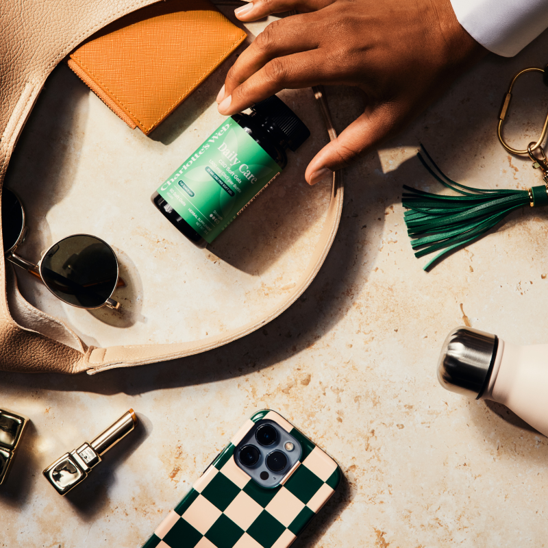 Person interacting with various items on a checkered tablecloth