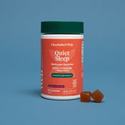 Product Image for Charlotte&#39;s Web Quiet Sleep mushroom gummies container with two gummies on a blue background