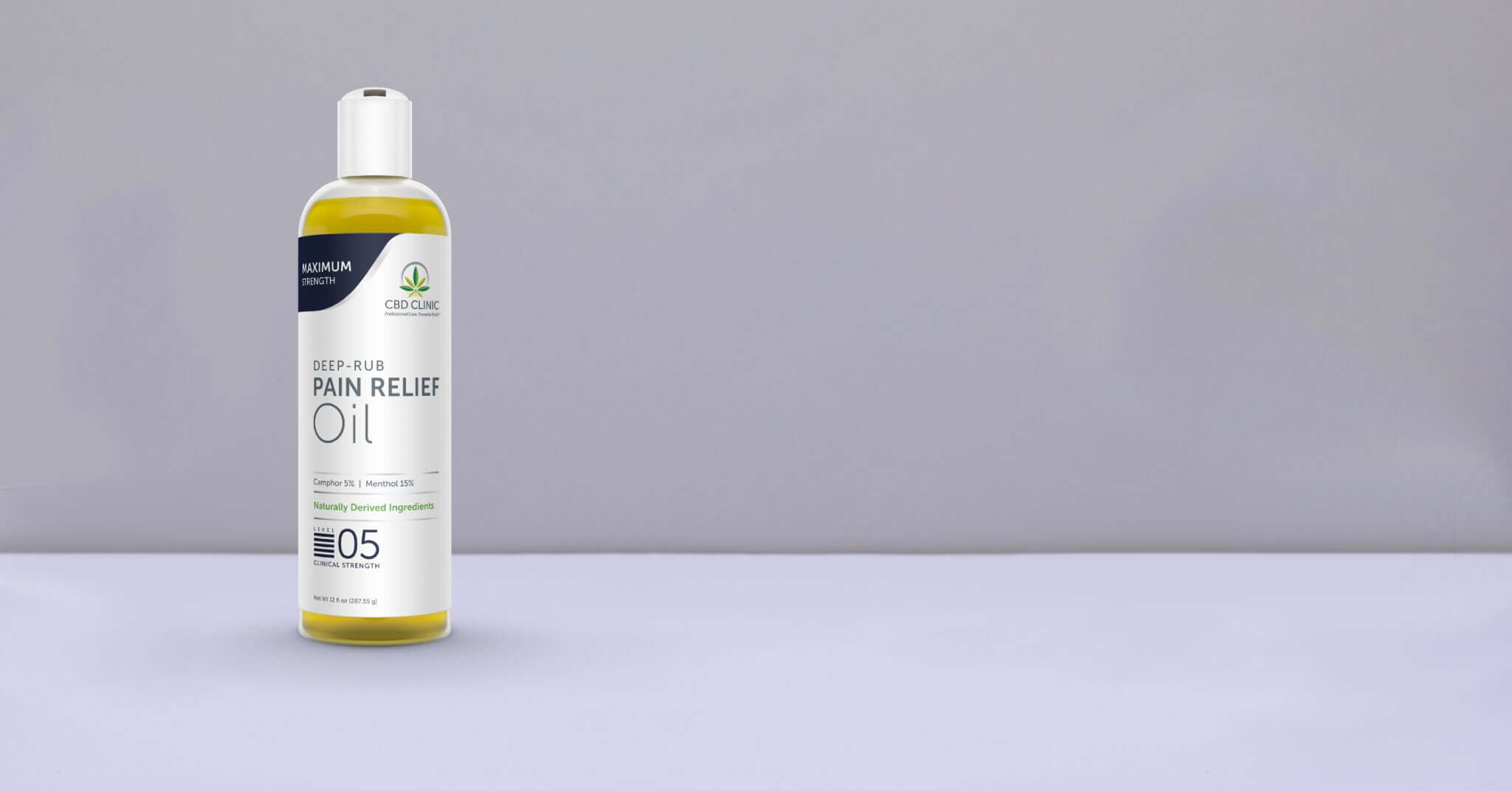 Bottle of pain relief oil on a gray background