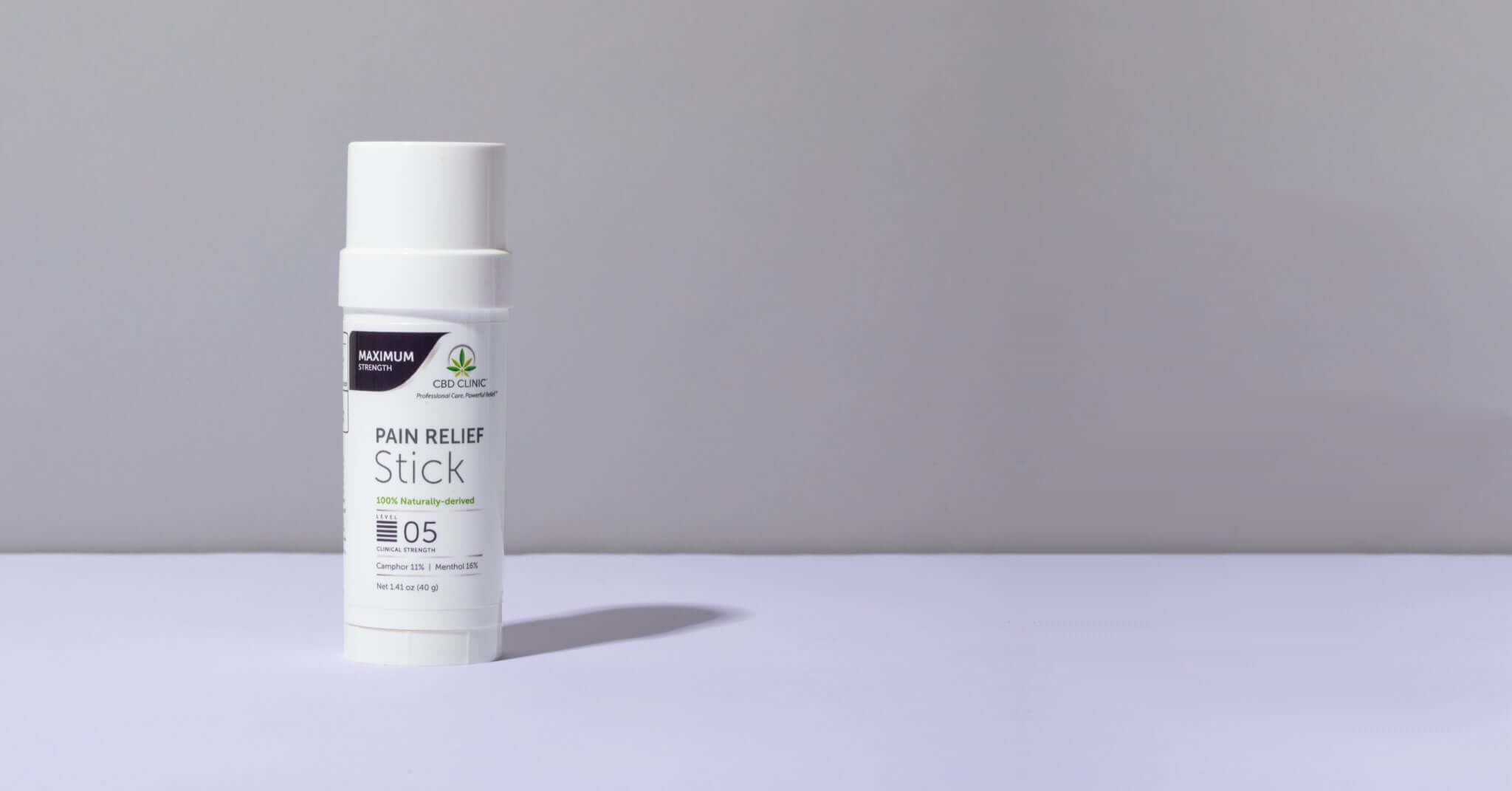 Pain relief stick on a gray background